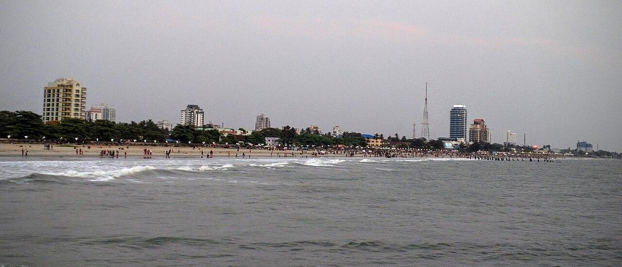 Kozhikode Beach, with the paved walk, the sea wall and the Arabian Sea under a cloudy sky